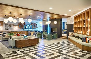 A lobby with couches and chairs and a fireplace